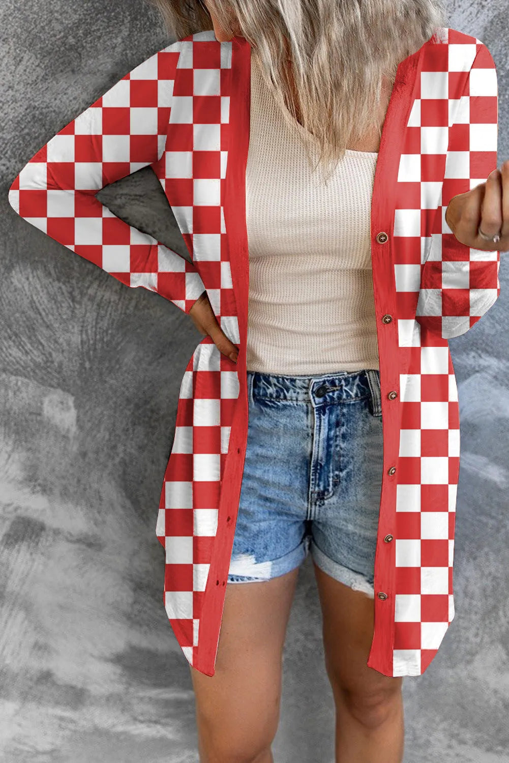 Long grey women's plaid patterned loose knit cardigan coat with regular sleeves on a hanger.