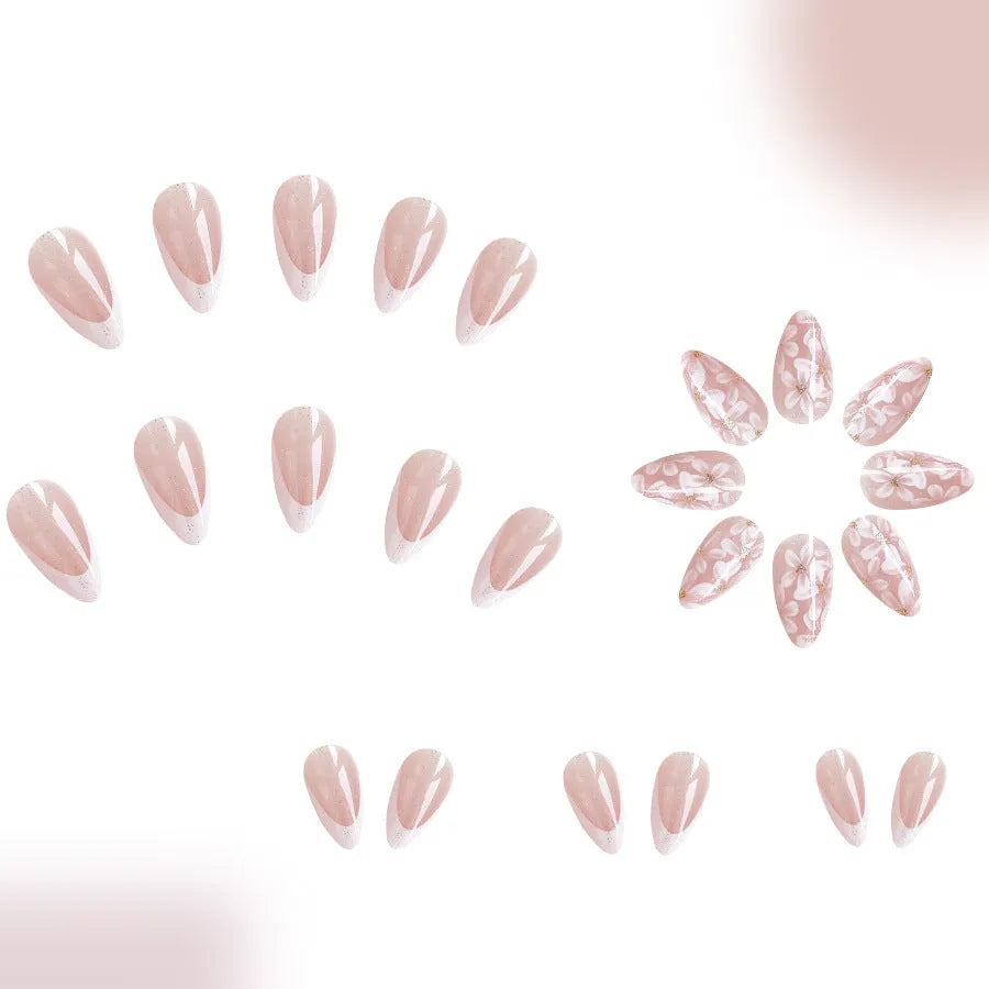 Short almond false nails with French manicure style and glittering floral powder accents in C625 colour