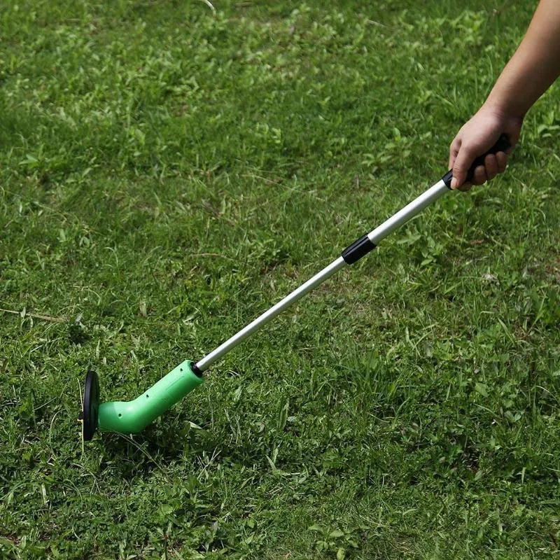 Cordless lawn trimmer weed trimmer with extension pole and debris shield on green grass