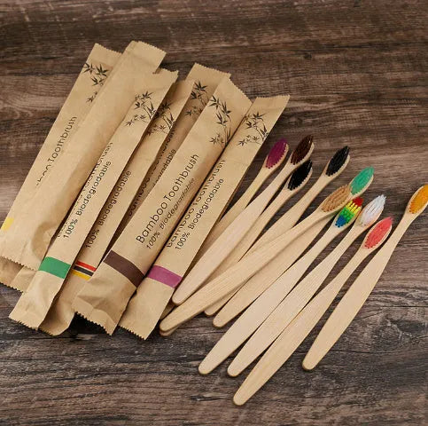 10 bamboo toothbrushes with soft charcoal bristles in assorted colours arranged fanned out