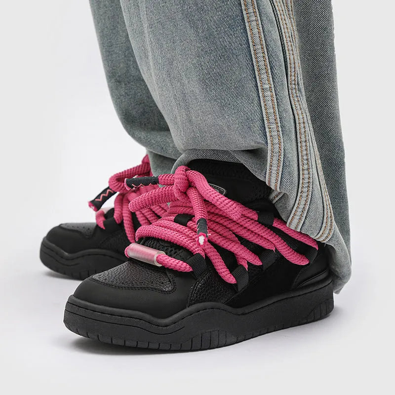 A pair of low-top unisex casual shoes with a round toe, thick rubber sole, and lace-up front on a white background.