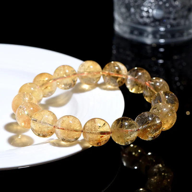 Natural yellow citrine bead bracelet showing geometric Asestelle cutting in both single and three-circle configurations