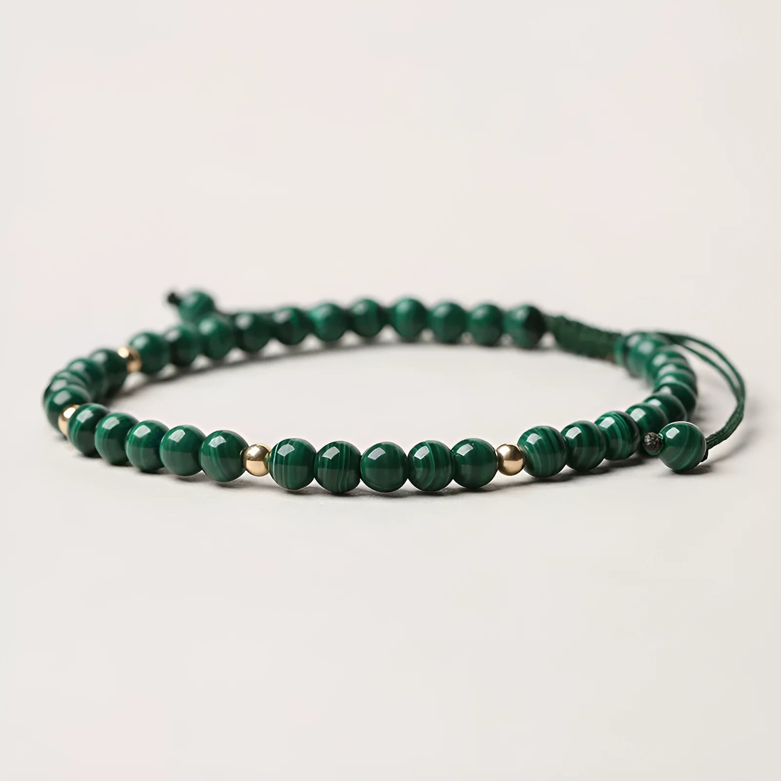 Natural malachite crystal bracelet for women with handwoven golden balls strap and textured green stone