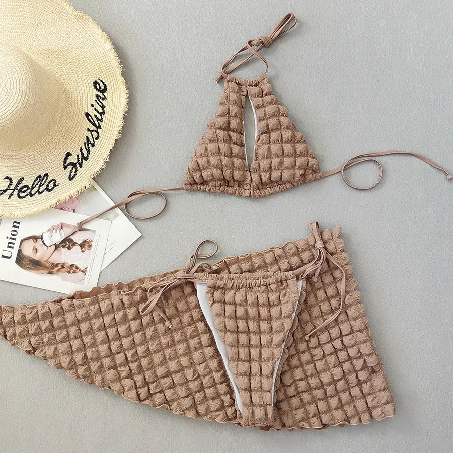 Woman wearing brown seersucker lace-up three-piece bikini swimsuit with separate skirt