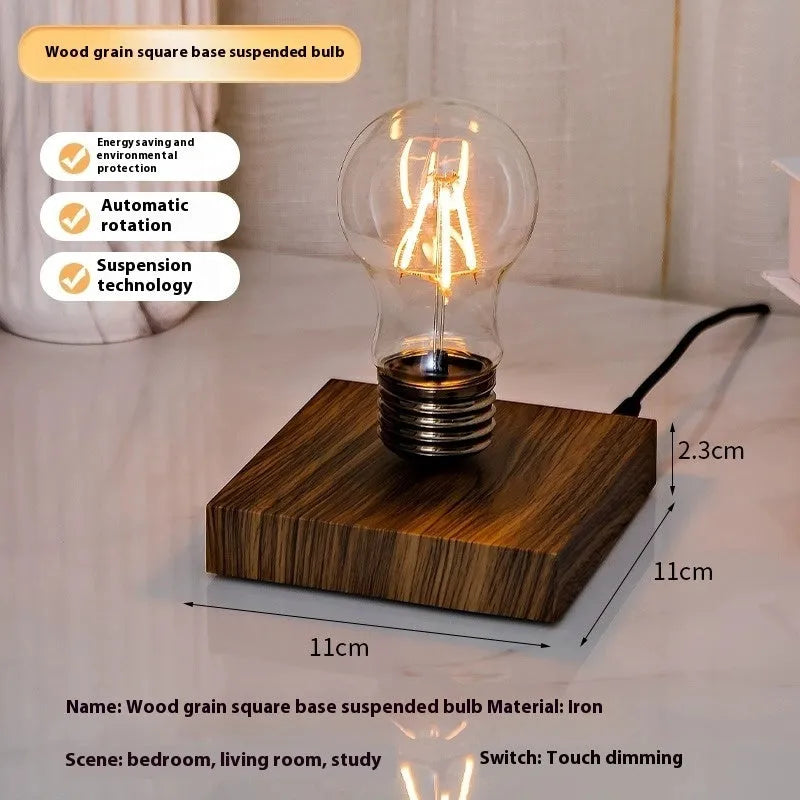 Small black suspension bulb night lamp with iron art body on a wooden base.