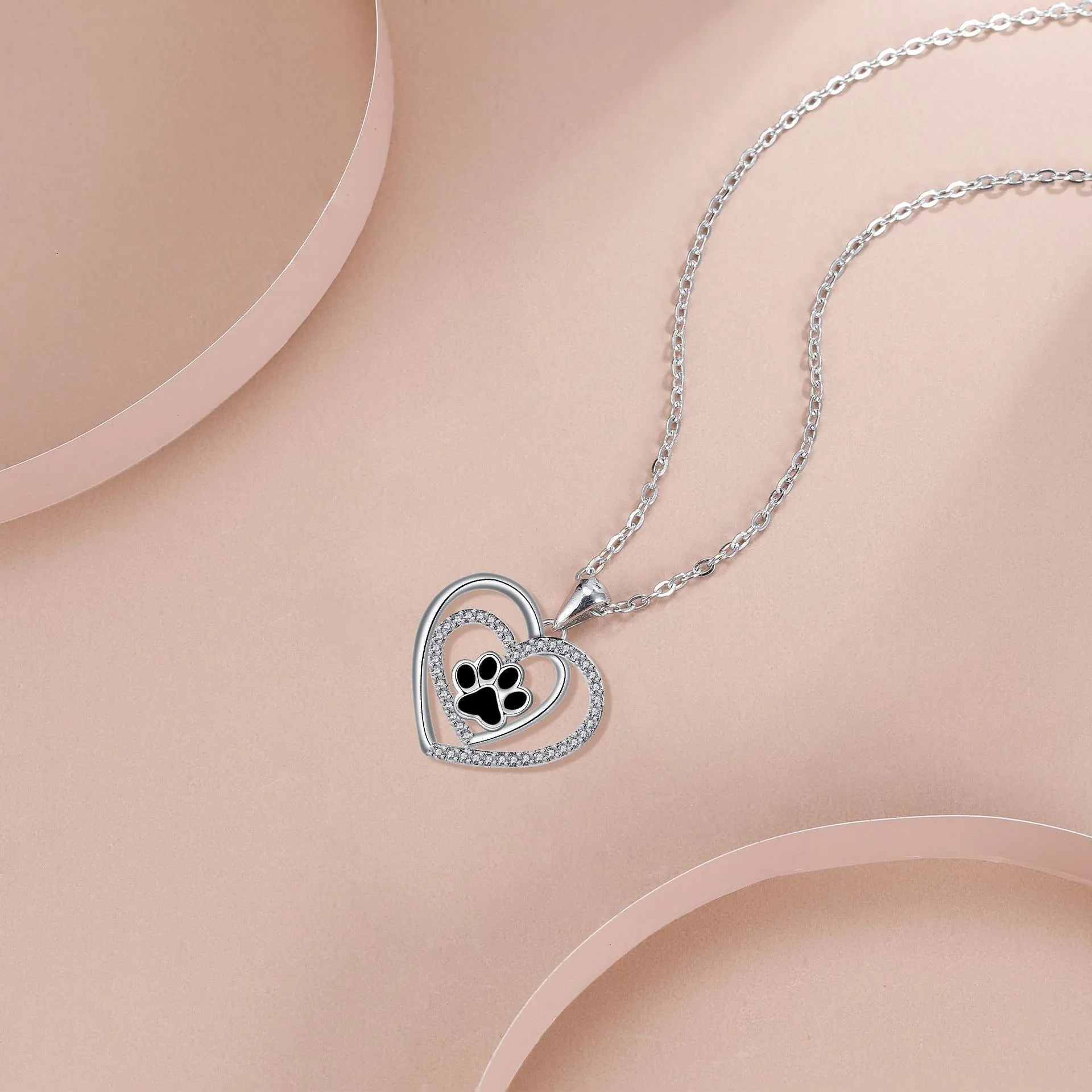 Original design women's necklace with copper dog paw print pendant on a cross chain.