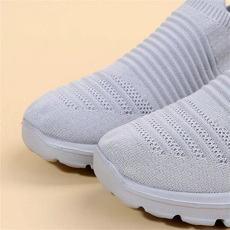 Women's knit sock shoes in beige with breathable upper, round toe, and low rubber sole