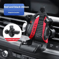 Racing seat shape car phone holder clipped to a car air vent with a gold tape colour finish