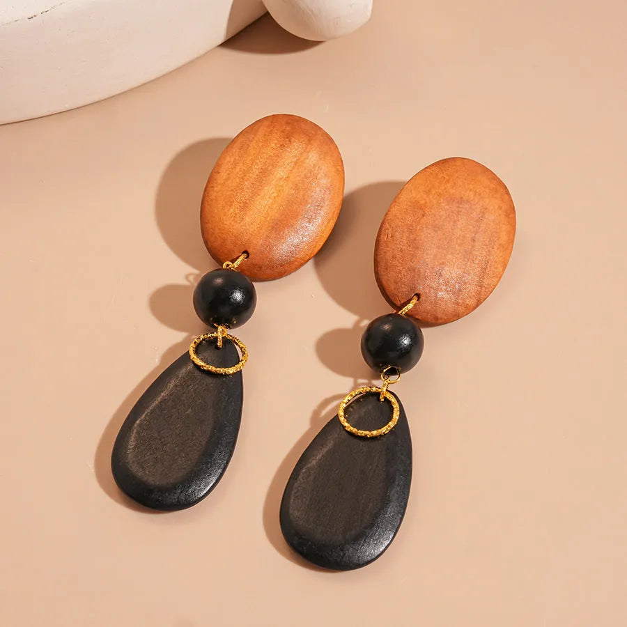 Handcrafted wooden retro earrings with elliptical design in silver brown black colours