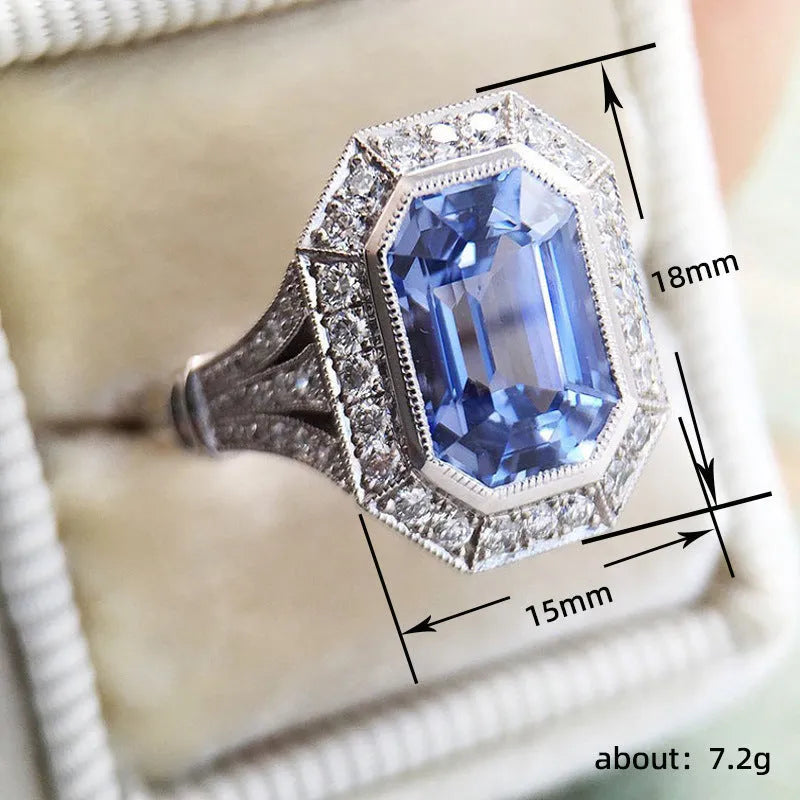 Blue long hexagon copper electroplated women's ring on plain background, sizes 6 to 10