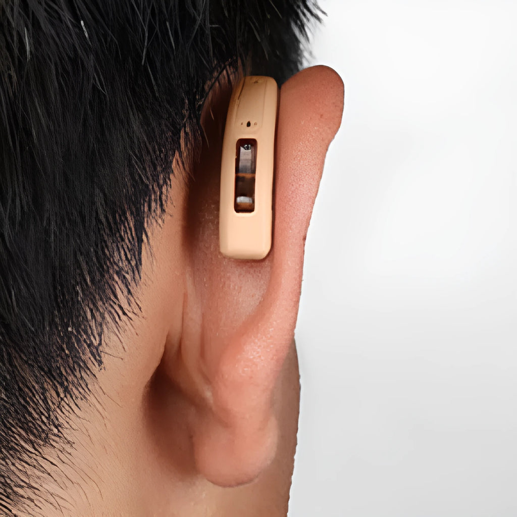 Wireless behind-the-ear Bluetooth digital hearing aid in black plastic with charging case and accessories