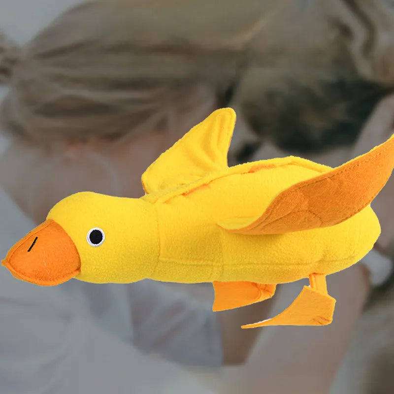 Yellow plush teddy duck dog toy with sound mechanism and treat leak hole for pet training