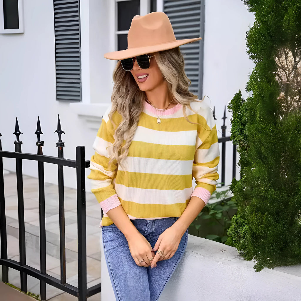 Loose fit women's acrylic sweater with round neck and long sleeves on a hanger