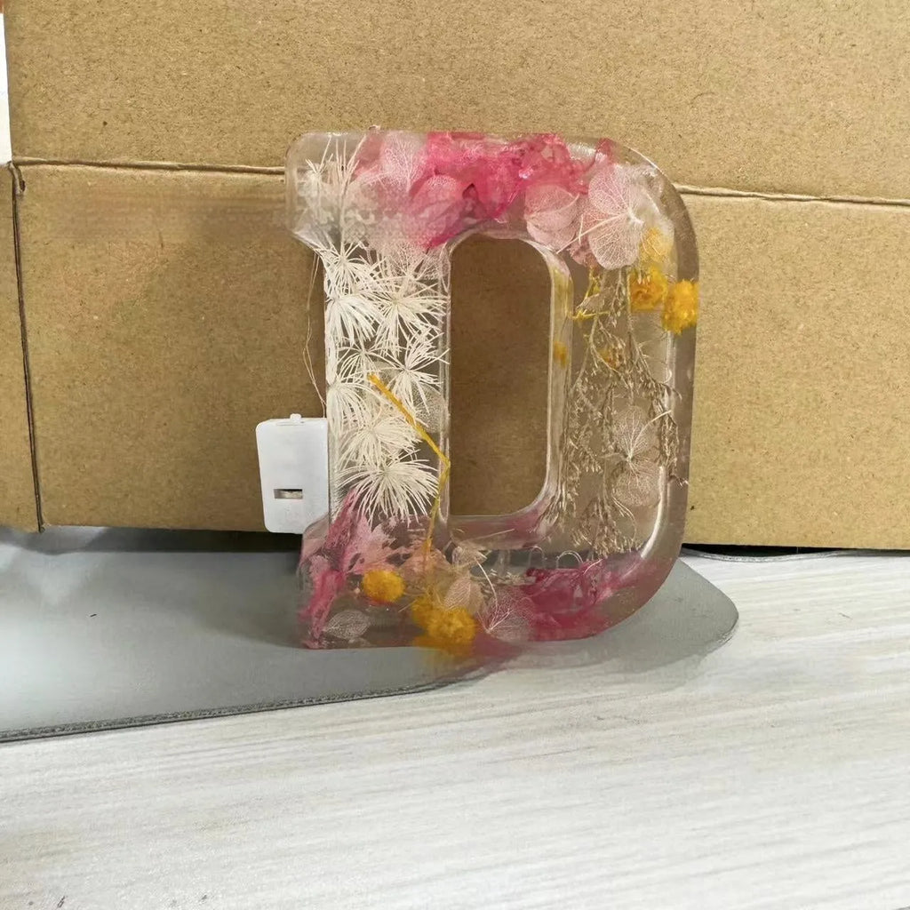Letter flower transparent resin night light ornament with 15cm dimensions on a table
