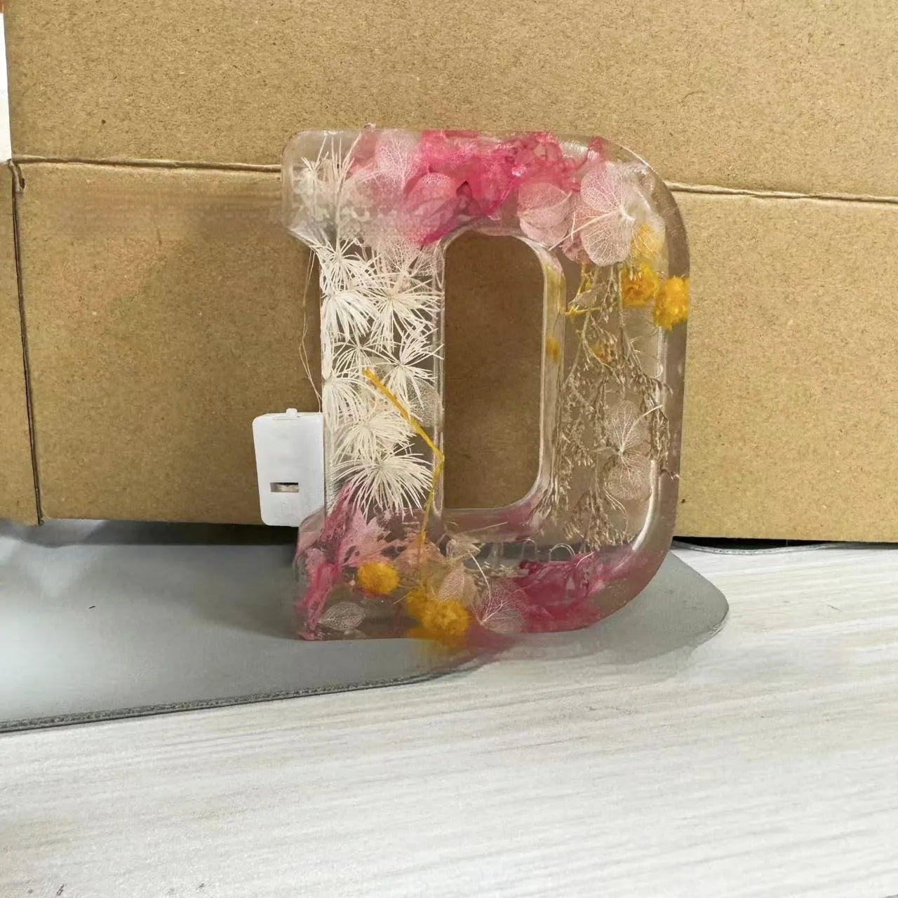Letter flower transparent resin night light ornament with 15cm dimensions on a table