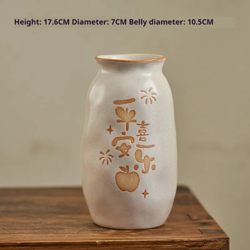 Chinese hand-painted ceramic joy vase with symbolic motifs on wooden desk