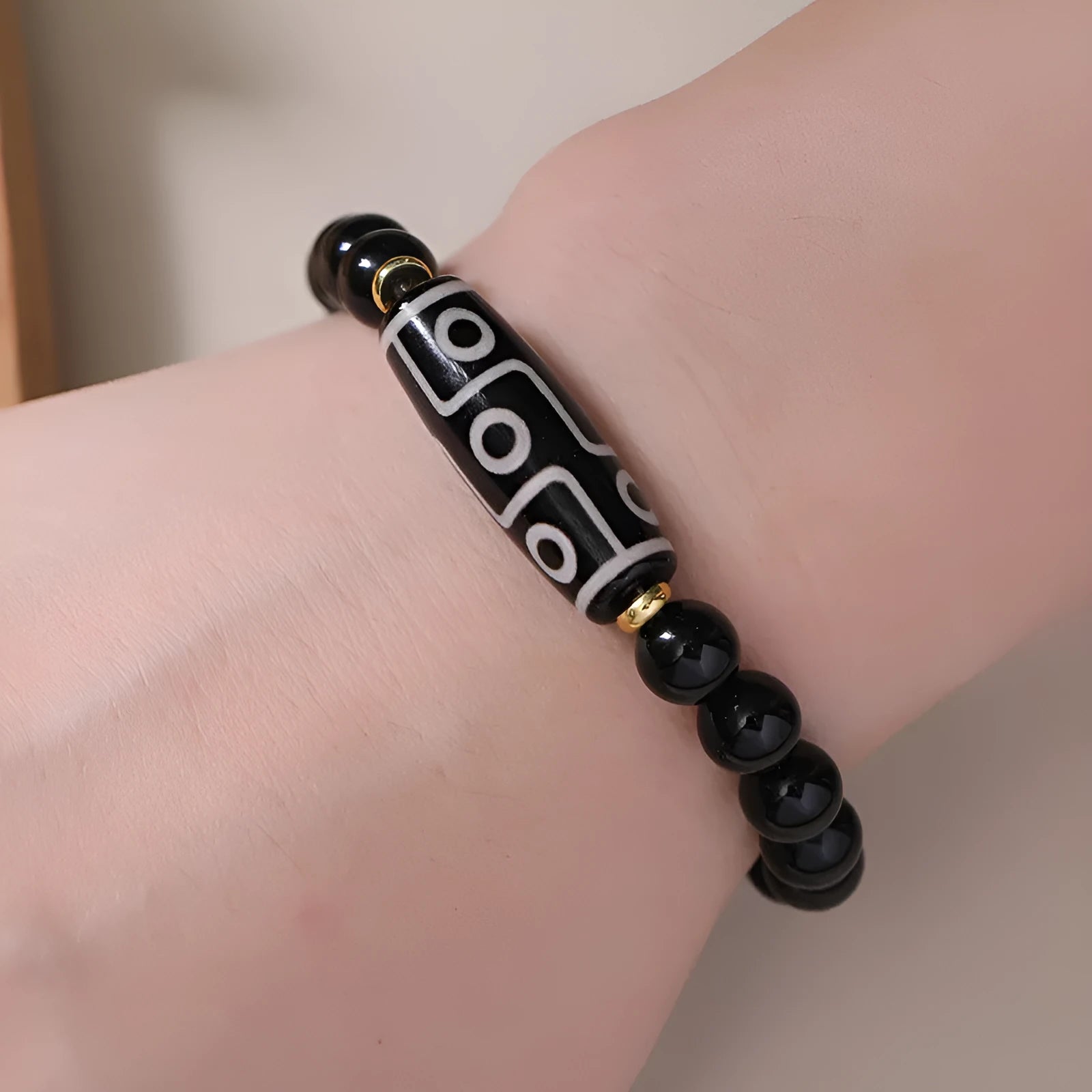 Ethnic style Tibet dzi bead bracelet in obsidian agate, unisex couple design on a neutral background