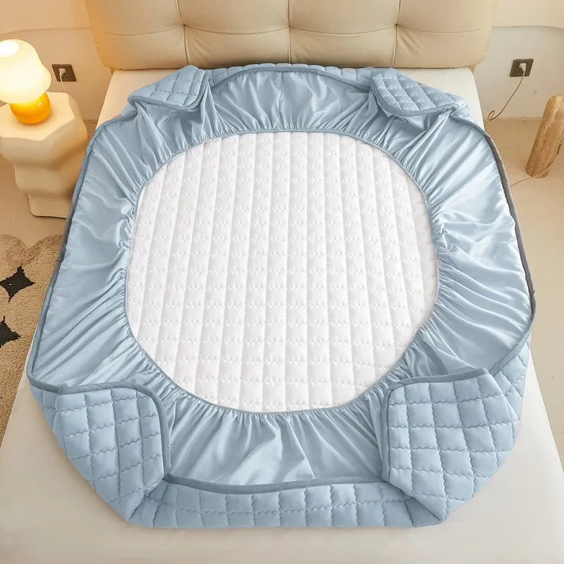 Blue quilted waterproof fitted sheet with elasticated corner on a mattress