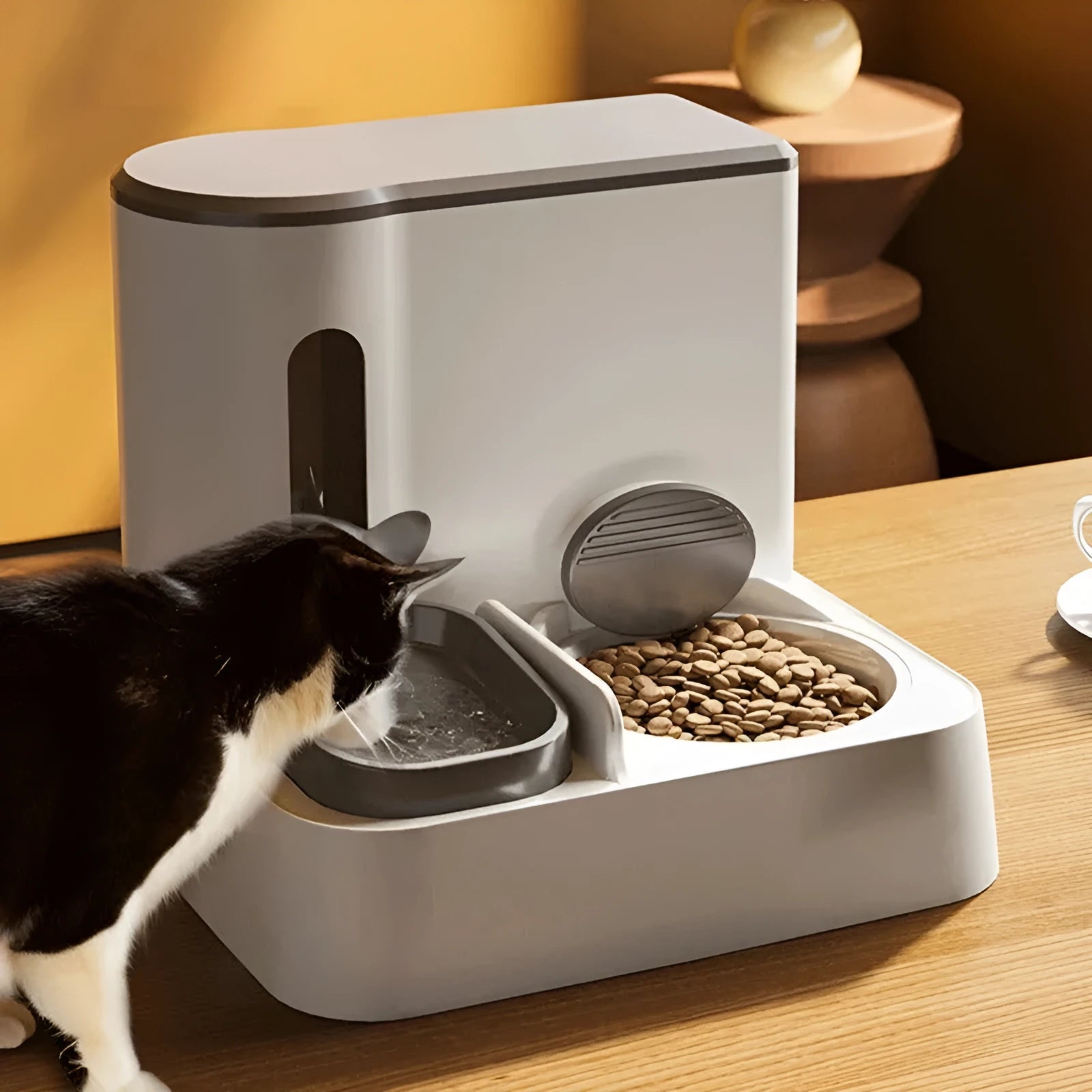 Grey automatic cat feeder with integrated water dispenser and stainless steel bowls