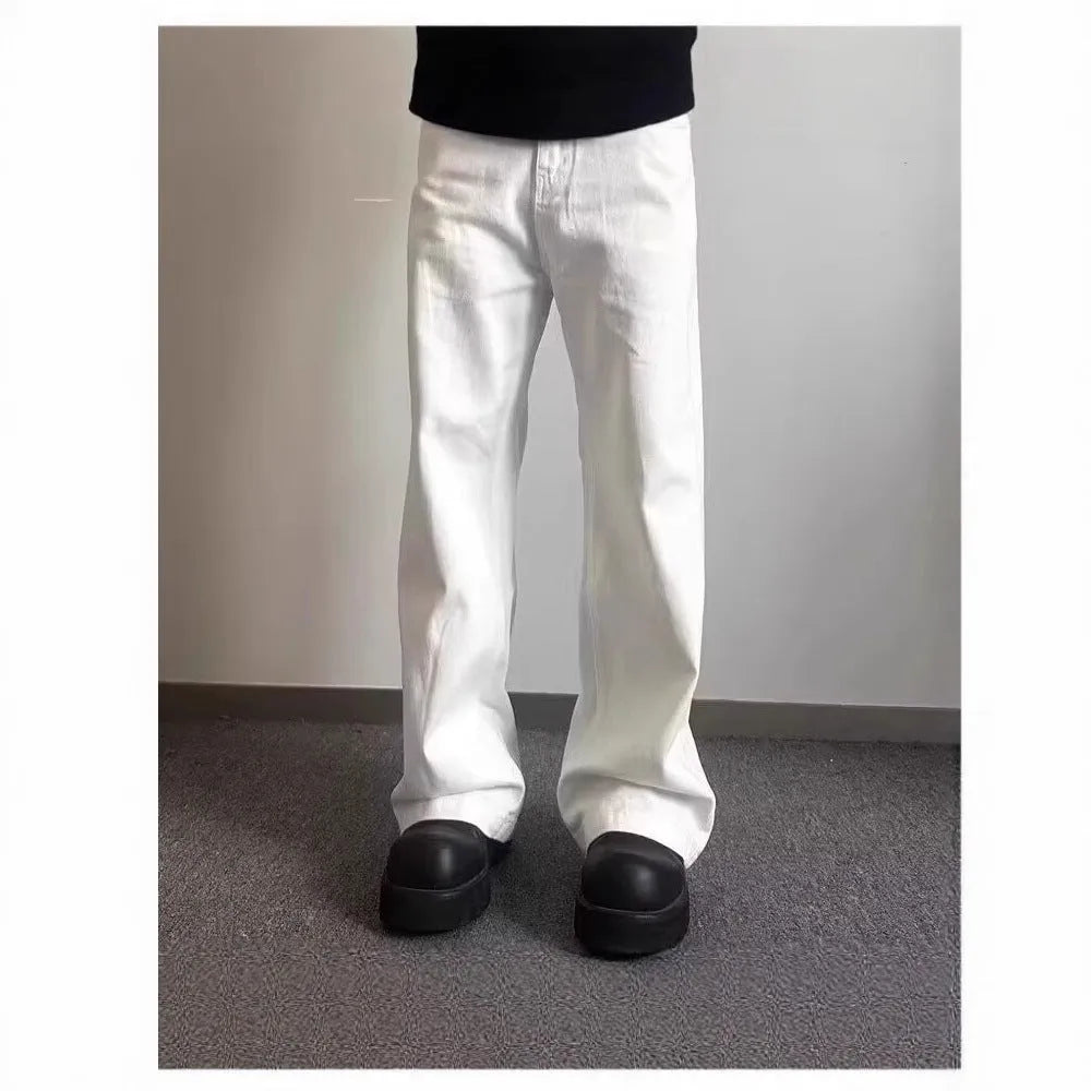 Men's white loose fit straight-leg cotton denim jeans on a plain background.