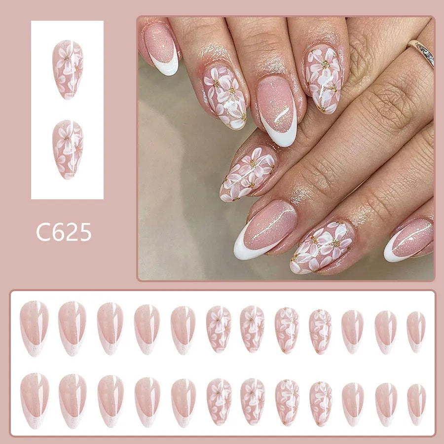 Short almond false nails with French manicure style and glittering floral powder accents in C625 colour