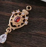 Silver tone crown motif hollow water drop copper pendant in five colours, measuring 12mm by 23mm.