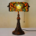 Tiffany stained glass table lamp with coloured glass shade on resin base for desk lighting