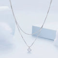 Silver double-layer necklace with pearl chain and sterling silver pendant.