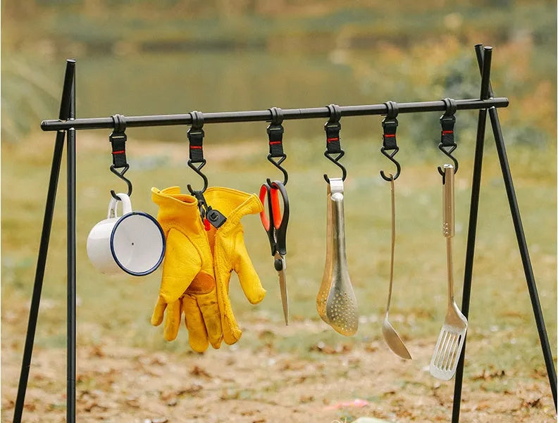 Large foldable aluminium camping drying rack with multiple hooks, set up outdoors.