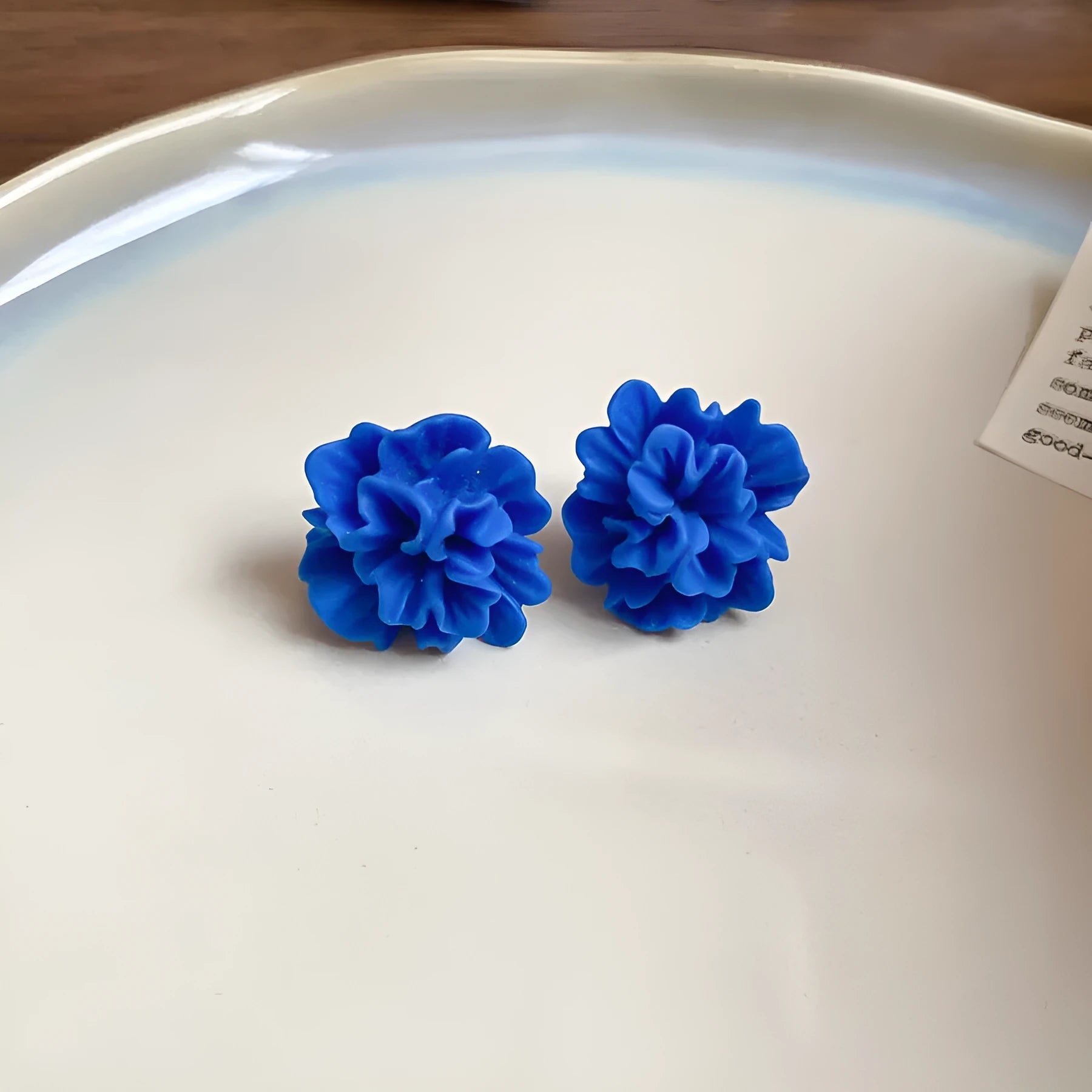 Women's geometric earrings with blue resin flowers on fabric in silver needle colour with circular design elements