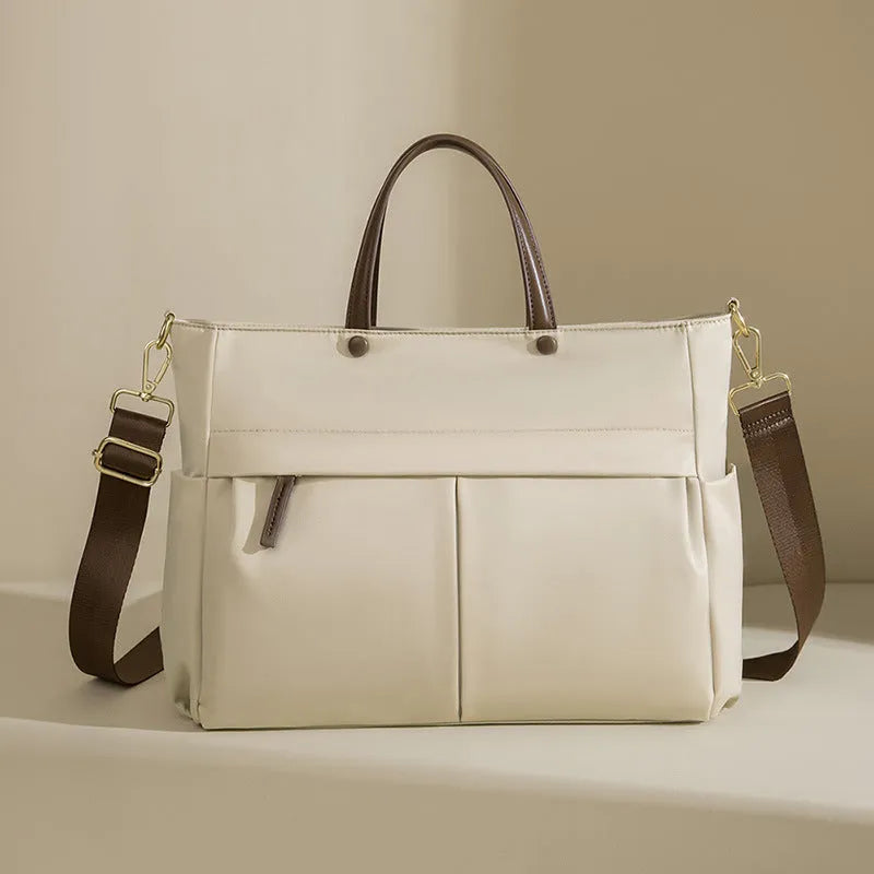 Women's Oxford cloth laptop briefcase showing elegant black colour with multiple open pockets and portable handle