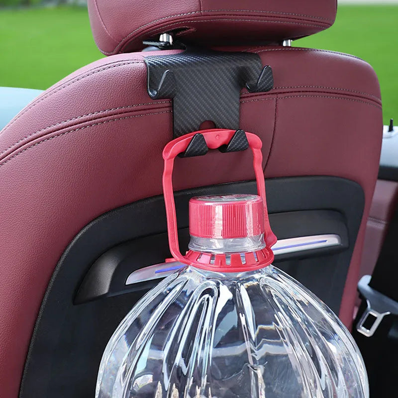 Black ABS plastic car seat back hook with integrated mobile phone holder bracket.