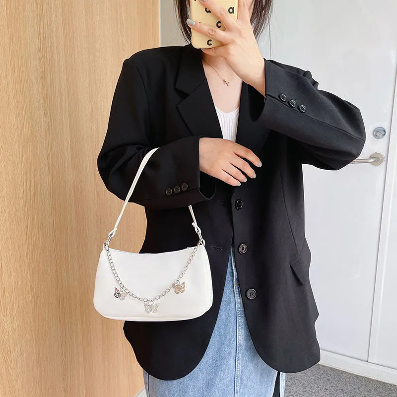 Black PU leather butterfly chain crossbody bag with a square shape and outer pocket.