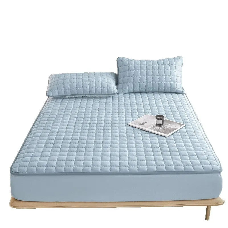 Blue quilted waterproof fitted sheet with elasticated corner on a mattress