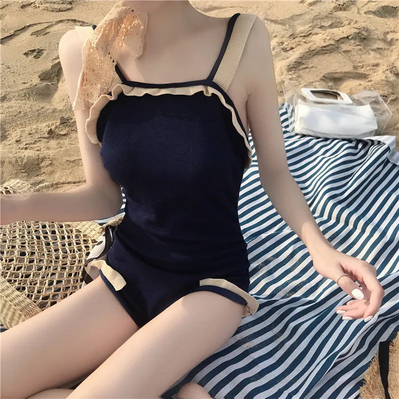 Women's conservative one-piece swimsuit in black with white edge, nylon fabric, size L