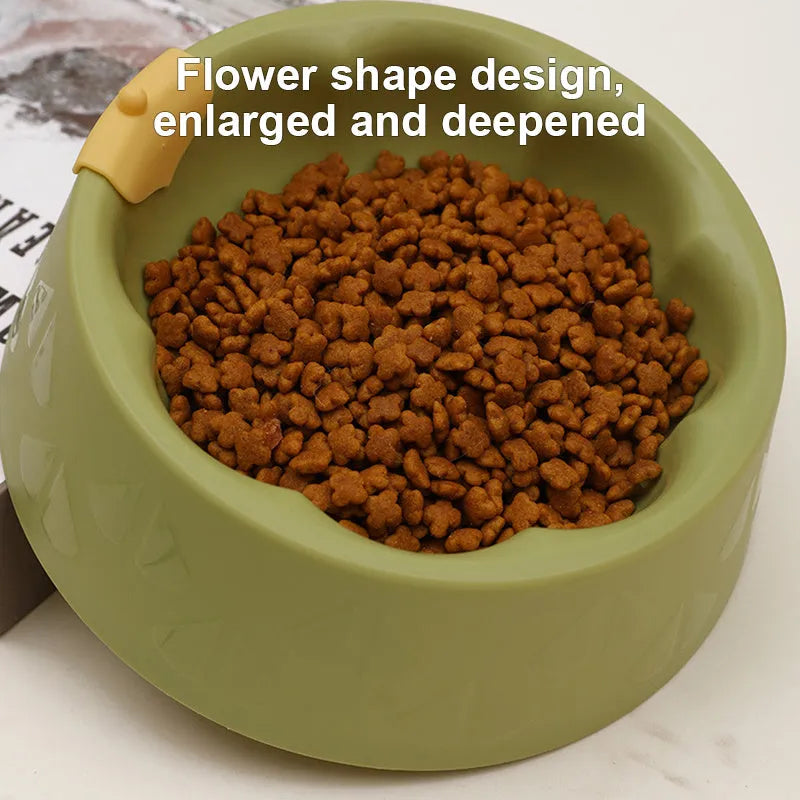 Green and yellow plastic double pet bowl for food and water on a flat surface.