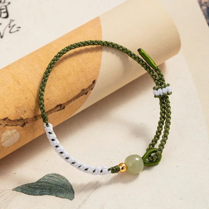 Chinese bracelet with Hetian Jade bead, sterling silver fittings, and adjustable coloured cord strap