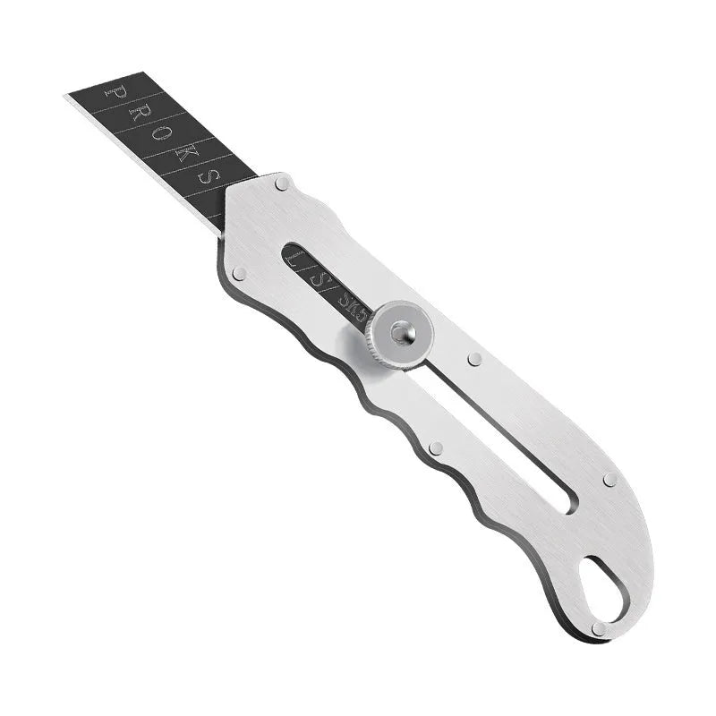 Stainless steel folding art knife with black blade, showing open position on work surface