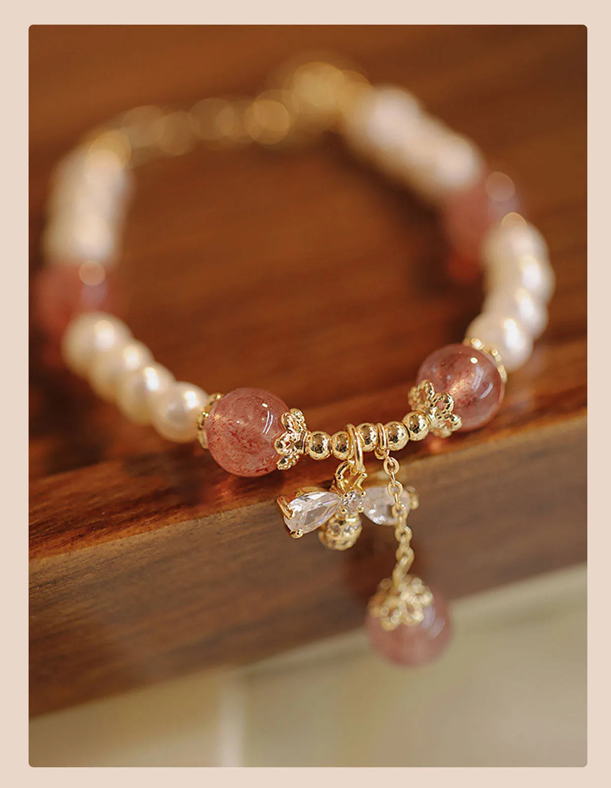 Crystal strawberry quartz bracelet with bow detail on white background, women's INS-style accessory