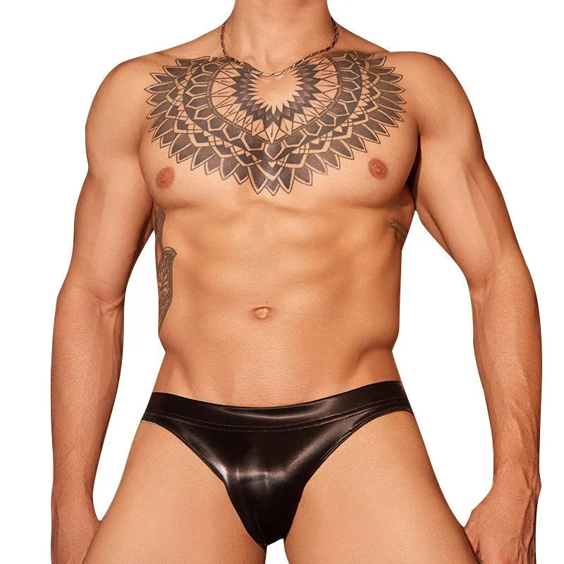 Men's black shark skin lace hip briefs on a white background, showing texture and cut.