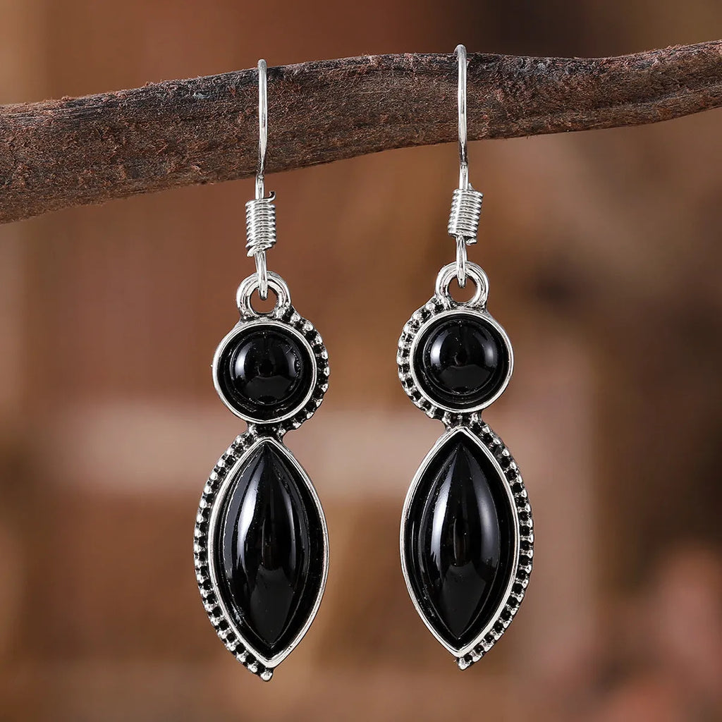 Pair of black and purple geometric vintage pendant earrings with round decorative elements