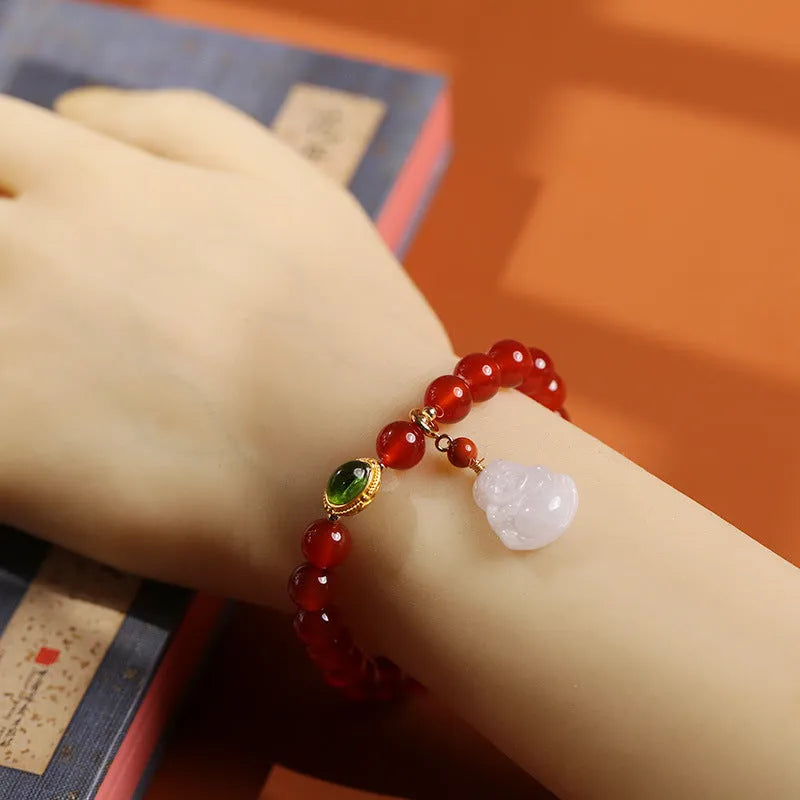 Chinese style women's bracelet with red agate, amber beads and gold Maitreya Buddha pendant on wrist