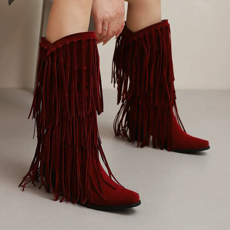 Women's beige suede below-the-knee boots with tassels and a chunky heel on a waterproof platform sole.