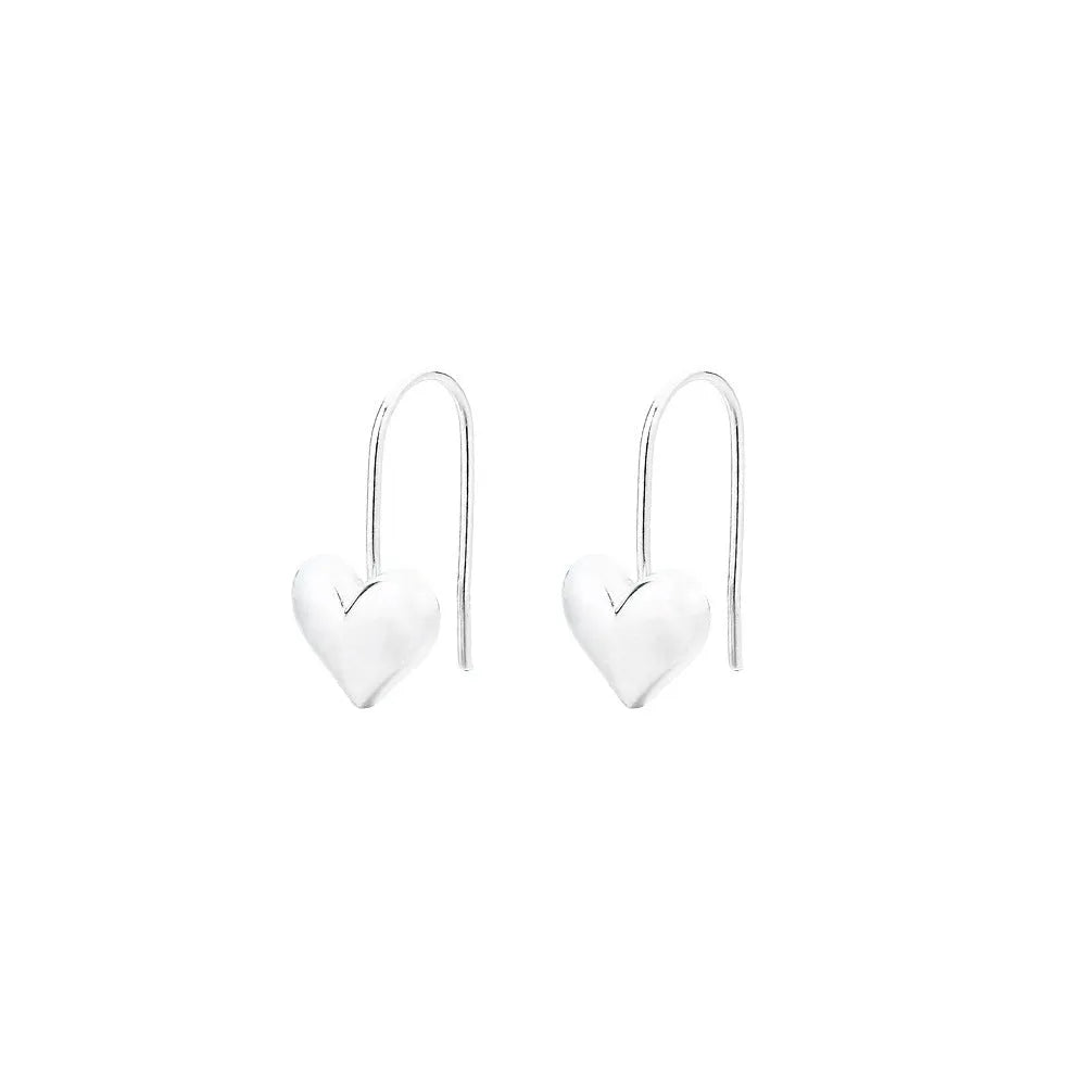 Close-up of glossy silver three-dimensional heart-shaped earrings on a white background.
