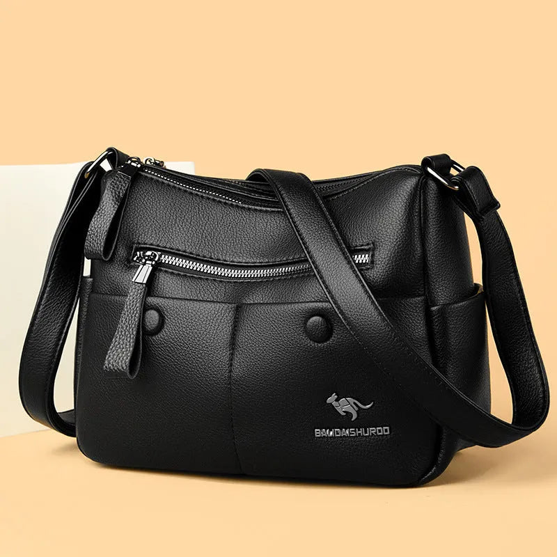 Soft PU leather crossbody bag in horizontal square shape with stitching detail, showing multiple colour options black dark blue wine red yellow.