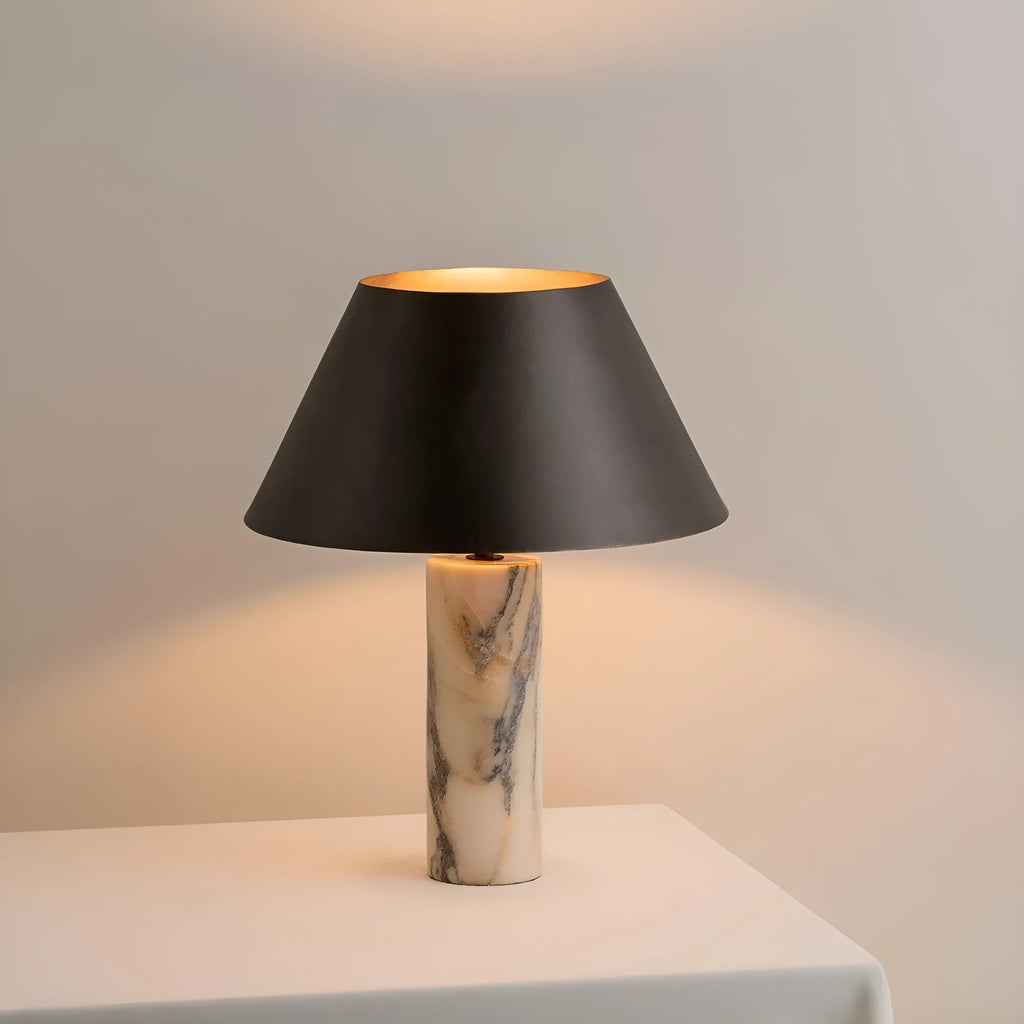 Black marble table lamp with modern minimalist design on wooden surface