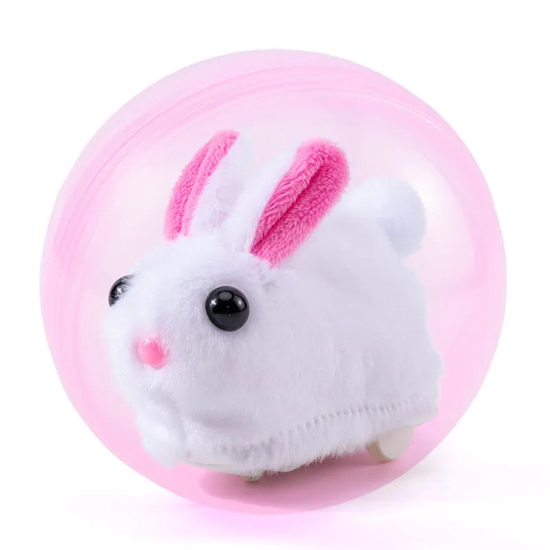 Hamster rolling ball toy set with transparent plastic sphere, plush shell in beige, and battery base on a floor