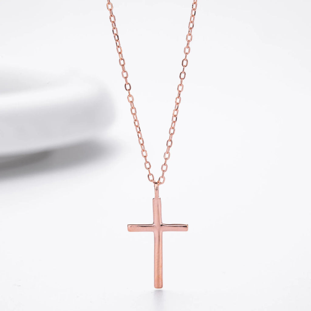 Simple glossy cross pendant on an O-chain sterling silver necklace in gold plating.