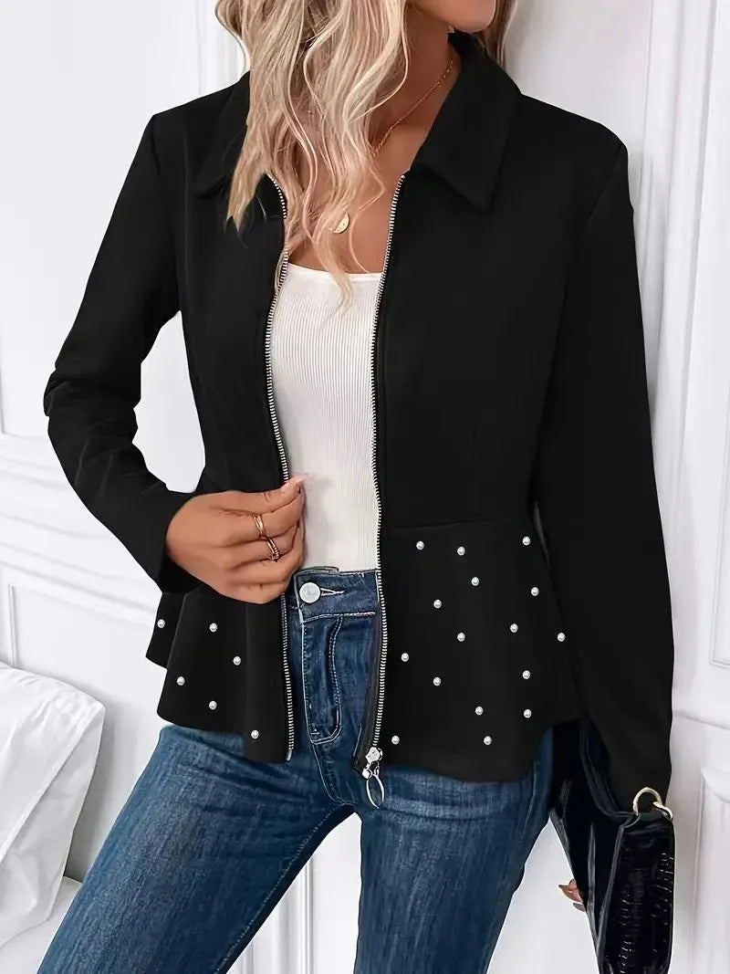 Women's loose black coat with beaded heavy-duty zipper and ruffled hem, shown on a hanger.