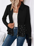 Women's loose black coat with beaded heavy-duty zipper and ruffled hem, shown on a hanger.